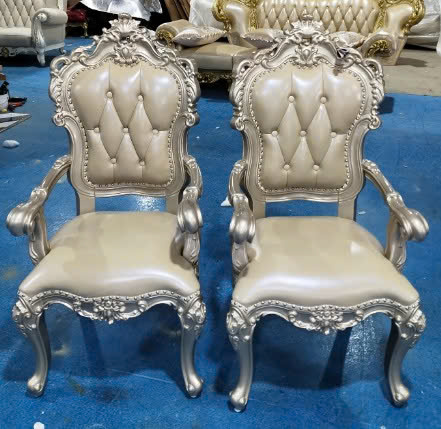 Cặp ghế ăn tân cổ điển có tay GVC100-NT được chụp từ góc nhìn hơi cao trong không gian trưng bày. Khung ghế gỗ sồi với lớp…