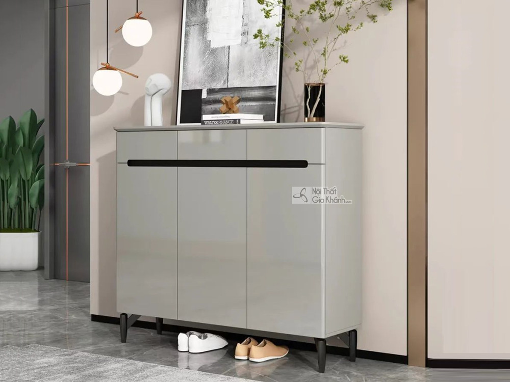 Tủ giày hiện đại TDA-120 được chụp chính diện, đặt trong không gian tiền sảnh hoặc lối vào nhà. Tủ có thiết kế tối giản vớ…