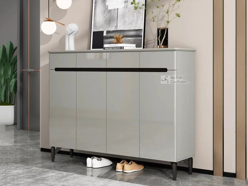 Tủ giày hiện đại TDA-140 được chụp chính diện, hơi chếch sang phải, đặt trong không gian tiền sảnh hoặc hành lang. Tủ có b…