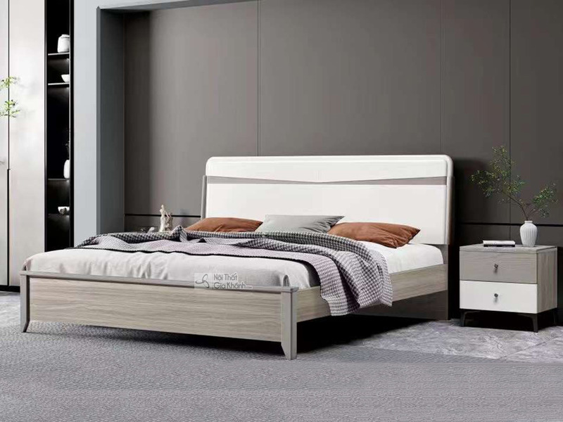Giường ngủ hiện đại GI2305-1 và tủ đầu giường được chụp từ góc chính diện, hơi chếch sang phải, đặt trong phòng ngủ tối gi…
