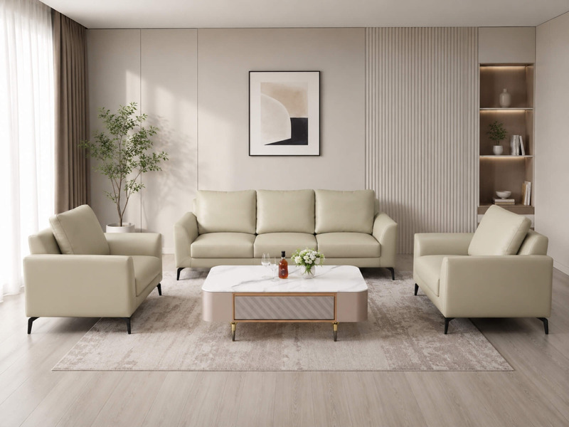 Bộ sofa Matera E001-113 da Nano màu kem nhạt, gồm một ghế băng dài, một ghế băng nhỏ và một ghế đơn, được bố trí trong phò…
