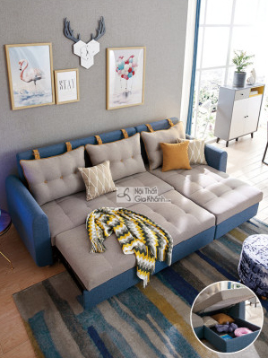 Sofa giường góc chữ L bọc vải màu xanh dương và be, được mở rộng hoàn toàn thành giường ngủ tiện lợi. Hình ảnh chụp từ trê…