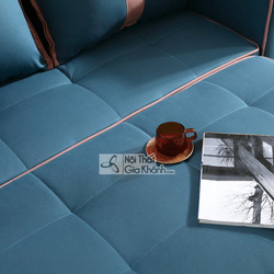 Cận cảnh bề mặt sofa SF1012B-3 khi đã được mở rộng thành giường, cho thấy rõ chất liệu vải màu xanh đậm được chần ô vuông…