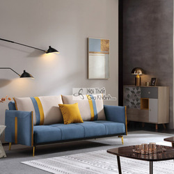 Sofa giường SF197-2G màu xanh dương đậm, đặt trong không gian phòng khách hiện đại. Sofa có thiết kế băng dài, tựa lưng và…
