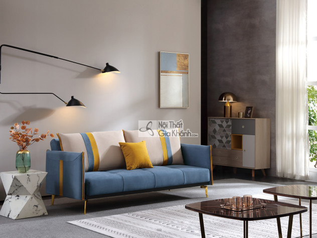 Sofa giường SF197-2G màu xanh dương đậm, đặt trong không gian phòng khách hiện đại. Sofa có thiết kế băng dài, tựa lưng và…