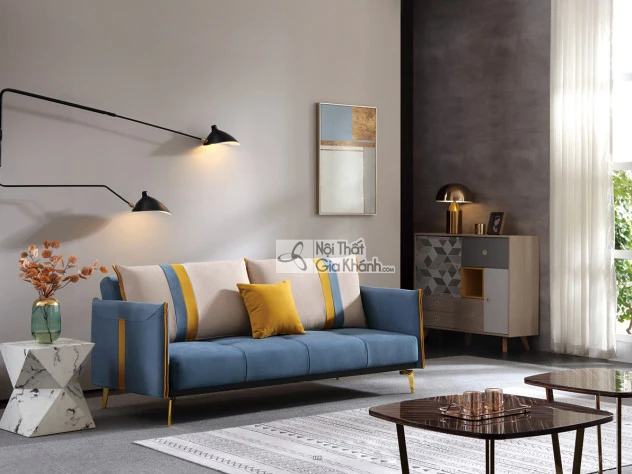 Sofa giường SF197-2G màu xanh dương đậm, đặt trong không gian phòng khách hiện đại. Sofa có thiết kế băng dài, tựa lưng và…