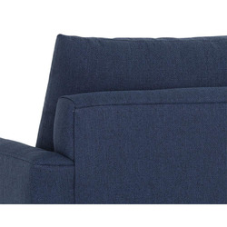 Cận cảnh chi tiết phần tay vịn và đệm tựa lưng của sofa băng bọc vải màu xanh đậm. Hình ảnh cho thấy rõ kết cấu vải dệt ca…