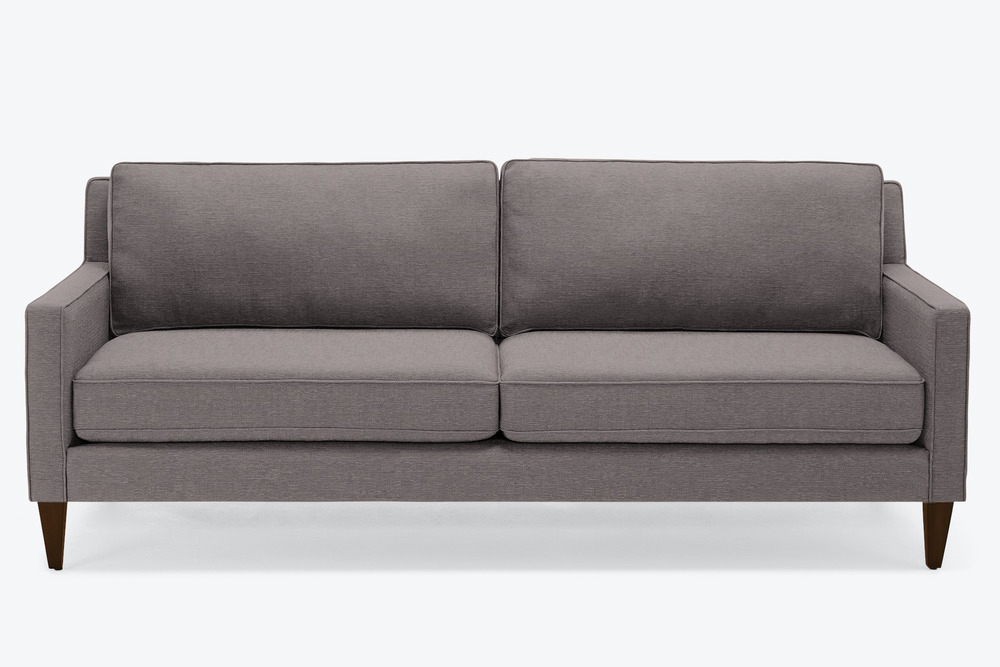 Sofa băng bọc vải màu xám đậm, chụp chính diện, đặt trên nền trắng. Kiểu dáng thanh lịch, hiện đại với các đường nét vuông…
