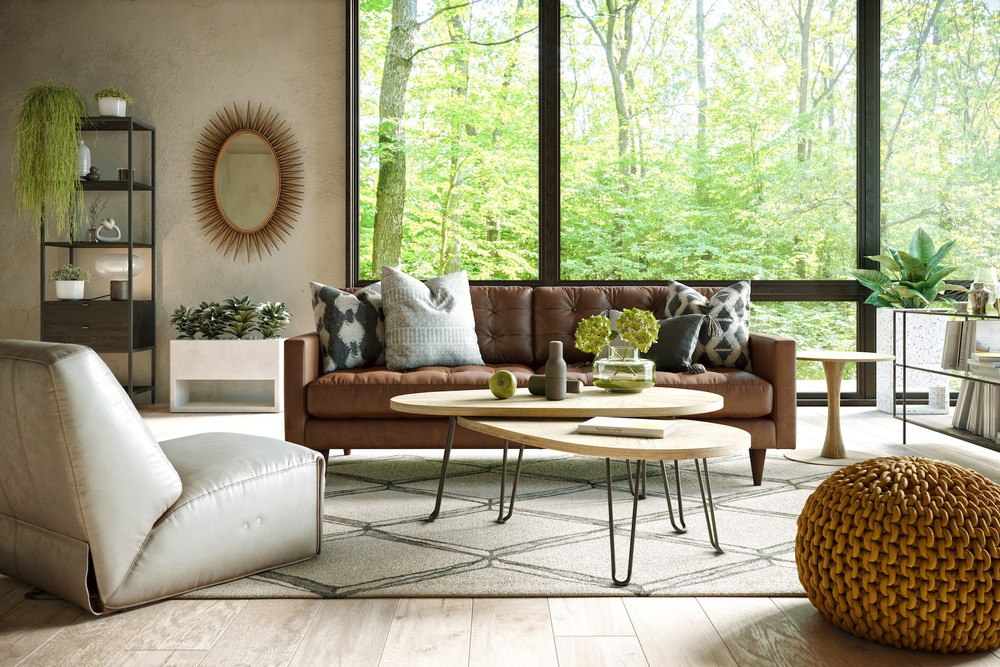 Sofa băng bọc da màu nâu caramel, đặt trong phòng khách hiện đại với cửa sổ lớn nhìn ra khung cảnh cây xanh tươi mát. Sofa…