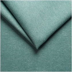 Hình ảnh cận cảnh chi tiết chất liệu vải bọc sofa màu xanh ngọc bích. Bề mặt vải có kết cấu dệt kim chặt chẽ, tạo cảm giác…