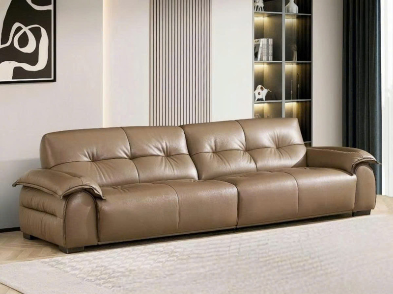 Ảnh chụp toàn cảnh sofa băng SFB8166 màu nâu be đặt trong không gian phòng khách hiện đại. Sofa có thiết kế tối giản với t…