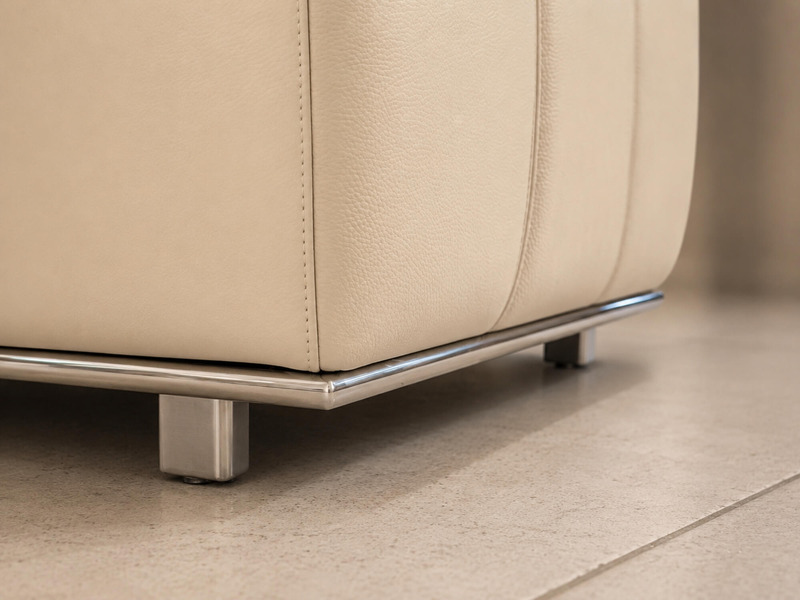 Góc chụp cận cảnh phần chân ghế đôn sofa H361-100, tập trung vào chi tiết viền chân Inox và chân trụ hình chữ nhật. Bề mặt…