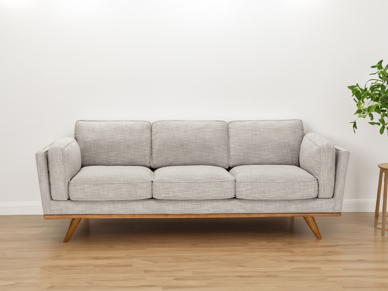 Ghế sofa băng 3 chỗ màu be nhạt đặt trong không gian phòng khách tối giản, tường trắng và sàn gỗ sáng màu. Bên cạnh là một…