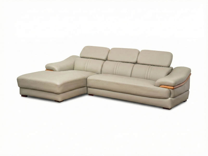 Sofa da góc phải màu be/ghi sáng, chụp từ góc cao phía trước, trên nền trắng tinh. Nổi bật kiểu dáng hiện đại với tựa đầu…