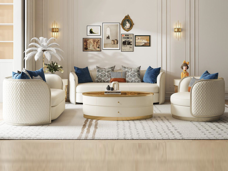 Bộ sofa phòng khách phong cách Mỹ luxury gồm một sofa băng dài và hai ghế đơn, bọc da/vải màu kem sang trọng. Ghế có tựa l…