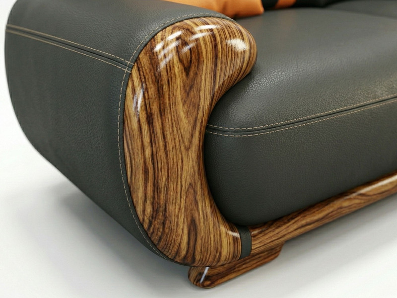 Cận cảnh tay vịn của ghế sofa băng dài, cho thấy rõ chi tiết gỗ Mun tự nhiên với vân gỗ độc đáo, uốn lượn mềm mại và được…