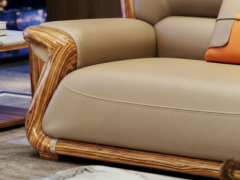 Cận cảnh phần góc của ghế sofa, tập trung vào sự kết nối giữa tay vịn và đệm ngồi. Khung gỗ Mun tự nhiên với vân gỗ đẹp mắ…