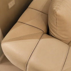 Chi tiết đường may chéo tinh xảo trên bề mặt da màu kem của sofa, tạo nên họa tiết độc đáo và tăng tính thẩm mỹ. Các đường…