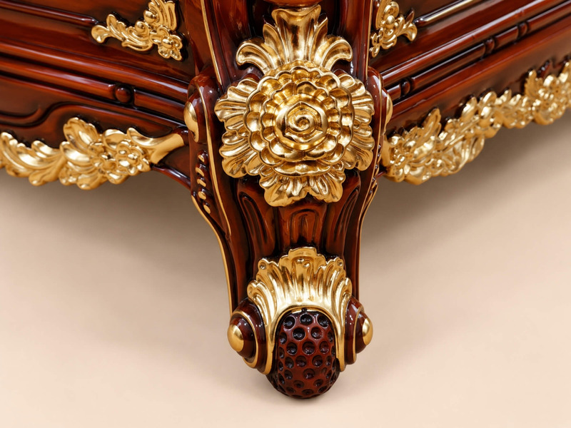 Cận cảnh chân bàn trà tân cổ điển, chụp từ góc thấp. Chân bàn gỗ Gõ Đỏ được chạm khắc hoa văn cầu kỳ, mạ vàng lấp lán…